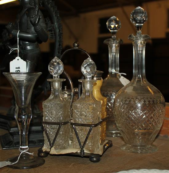 Wine glass with knopped stem, a pair of decanters and a four-bottle cruet